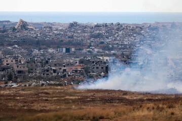 Buring fields in front of destroyed houses in northern Gaza