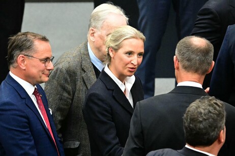 Friedrich Merz (R) is congratulated by co-leader of the far-right Alternative for Germany (AfD)