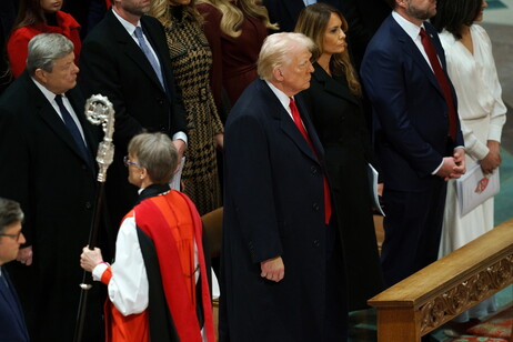 Reverend Mariann Edgar Budde (front) passes US President Donald Trump (C) during the National Prayer