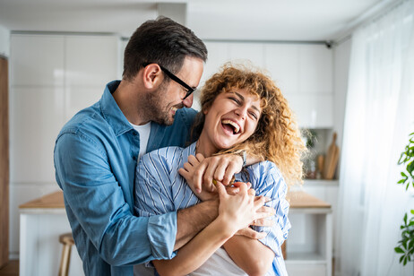 A wonderful scene of love and happiness between a couple in love enjoying their new apartment